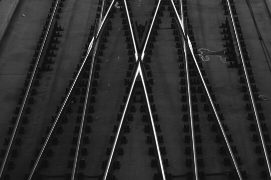 Metal railroad track rails and bolts glistening in light