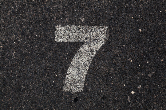 Number 7 Printed on White Over Dirty Asphalt