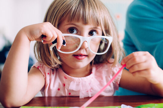 Girl Looking Over The Top Of Fake, White Glasses