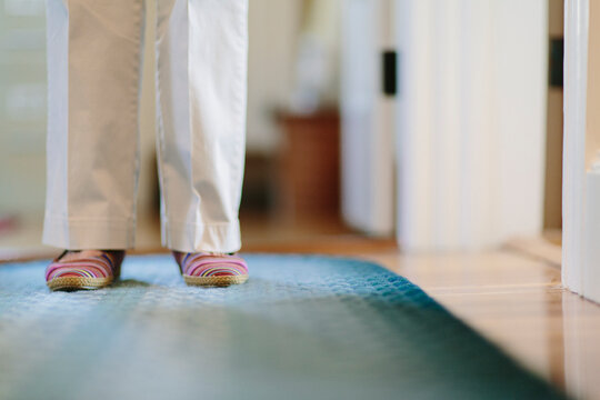 Senior Woman in Hallway of Home with Cozy slippers