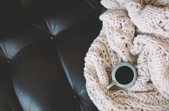 coffee and blanket on a sofa