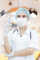 Fototapeta premium Female Medical Worker Holding a Syringe