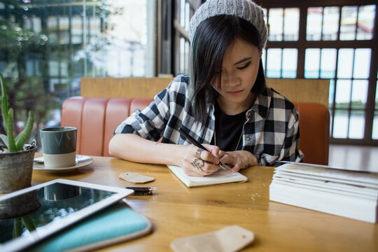 Young woman writing in her diary