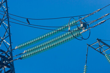 high-voltage power lines close-up, wires and insulators