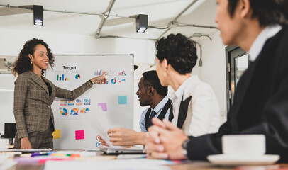 African American Businesswoman Leads the meeting It is explained using graph documents on a whiteboard in the meeting room at the office. Concept businesswoman leader meeting happy and smile.