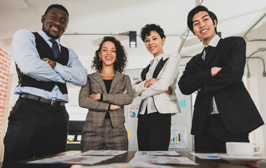 Business women and diversity men of different nationalities hugged their breasts and smiled, expressing the atmosphere after a successful meeting. Concept happy smile success.