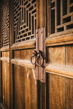 The knocker on the wooden door