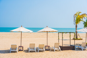 Umbrella and chair around outdoor swimming pool in hotel resort