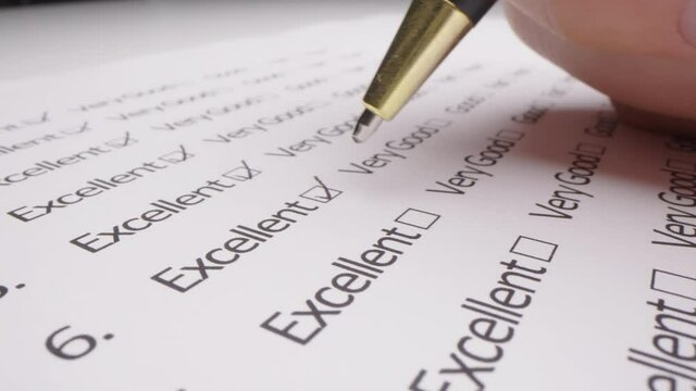 Motorized moving shot of completing an evaluation form, shot with macro probe lens