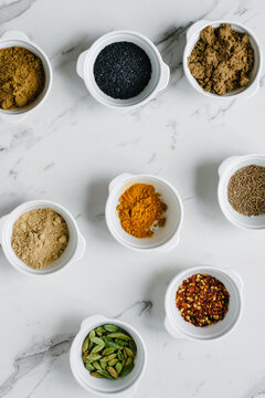 spices and seeds in white bowls