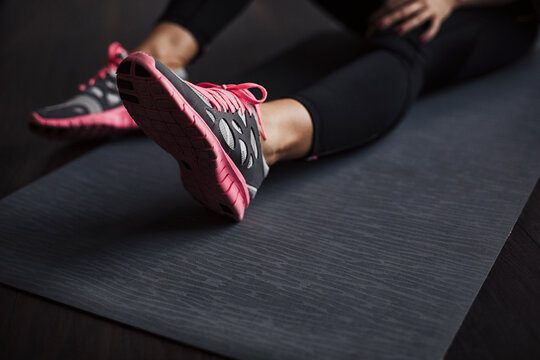 Woman Sitting on an Exercise Mat