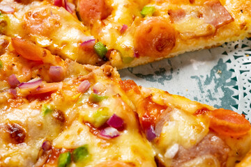 side view fresh pizza with bacon toppings with one piece missed close up