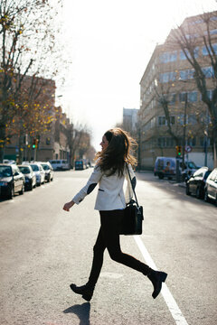 Busy businesswoman crossing the street.