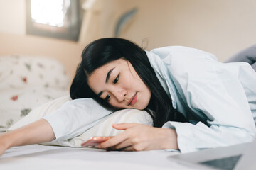 Young adult single woman using smartphone in the moring for social message app chat with friend