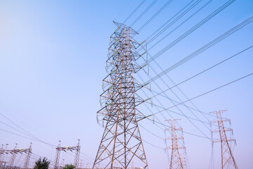 Electricity power plant substation in the morning light, Transmission line of electricity to rural field, Electricity tower with green nature landscape