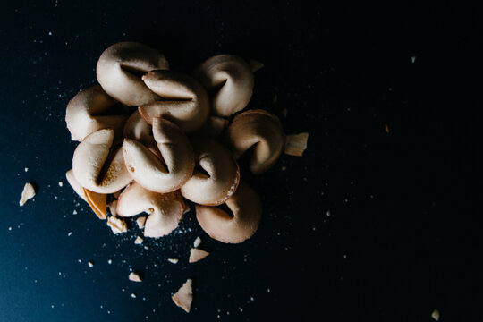 pile of fortune cookies on dark background