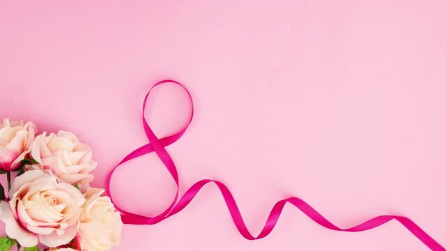 Pink ribbon and flowers appear on pink theme. Stop motion