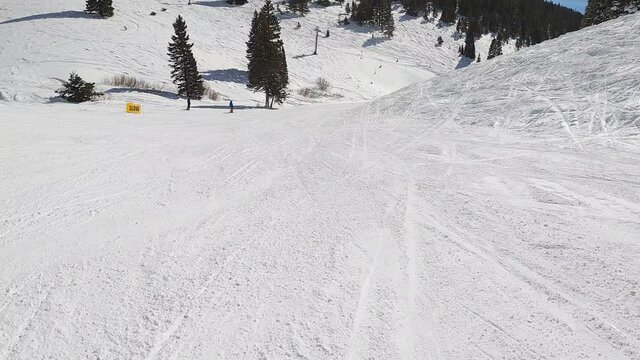 Follow Cam Of A Solo Woman Skiing On A Sunny Winter Day