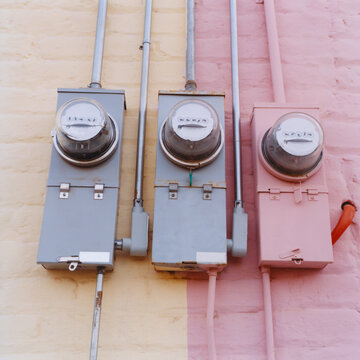 Row of electricity meters on colorfully painted building