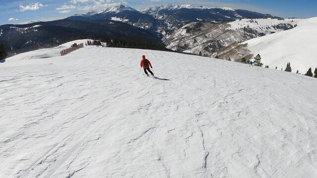 Follow Cam Of A Solo Woman Skiing On A Sunny Winter Day