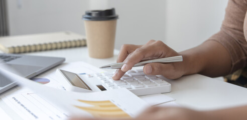 Financial businessman calculating corporate income tax data And analyzing charts of financial stocks that are in good condition with growth and progress, Investment in finance and accounting.