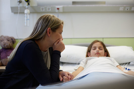Mother giving support to her child in a hospital room