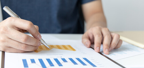 Financial businessman analyze the graph of the company's performance to create profits and growth, Market research reports and income statistics, Financial and Accounting concept.