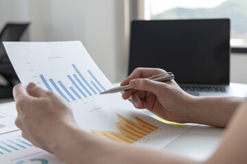 Financial businessman analyze the graph of the company's performance to create profits and growth,...