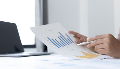 Financial businesswoman analyze the graph of the company's performance to create profits and growth, Market research reports and income statistics, Financial and Accounting concept.