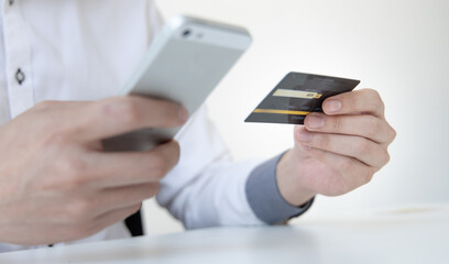 Businessman use mobile phones to register for security Online with a credit card to buy products online through application, Online shopping or Internet technology concept.