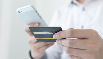 Businessman use mobile phones to register for security Online with a credit card to buy products online through application, Online shopping or Internet technology concept.