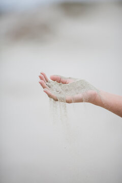 Sand Falling Through Woman's Fingers