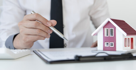 Fototapeta premium Sales manager or real estate agent will be prepared to show you a sample home and detail the terms of buying a home with insurance promotions, Attention to property services and insurance concept.