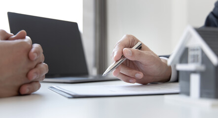 Real estate agent or sales manager has proposed terms and conditions to customers who sign house...