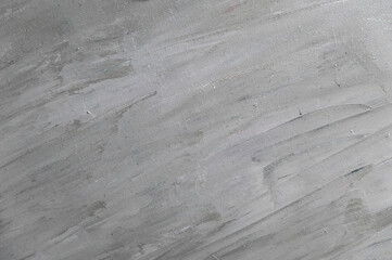 Fototapeta premium abstract gray background from smudged mixed color oil paint on linen canvas