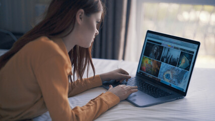 woman lies in bed in front of laptop freelance communication