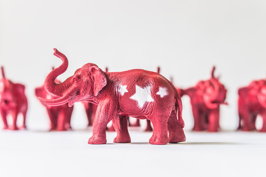 United States Republican Elephant Standing infront of A Row of Red Elephants