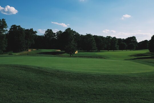 Golf course green and fairway in the late summer afternoon
