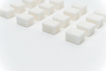 sugar cubes evenly spaced sweets ingredient light background