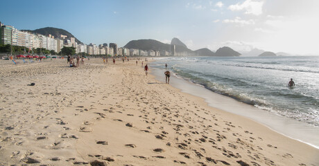   Citizens swim and sunbathe on the beach of Copacabana