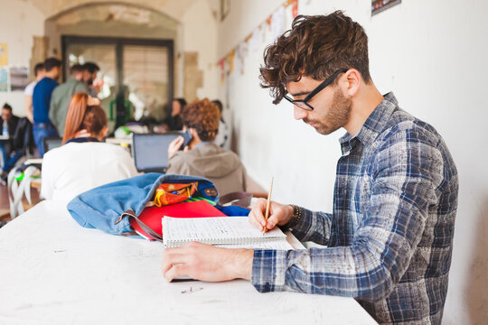Young Man Studying for the Final Exams at College