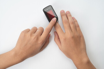 Top view of Pulse Oximeter, finger digital device to measure person's oxygen saturation. Reduced oxygenation is an emergency sign of pneumonia caused by flu or novel coronavirus. Device on Fingertip