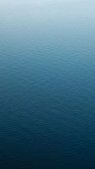 Foto op Plexiglas Vertical photography of a calm water surface © Danila Shtantsov