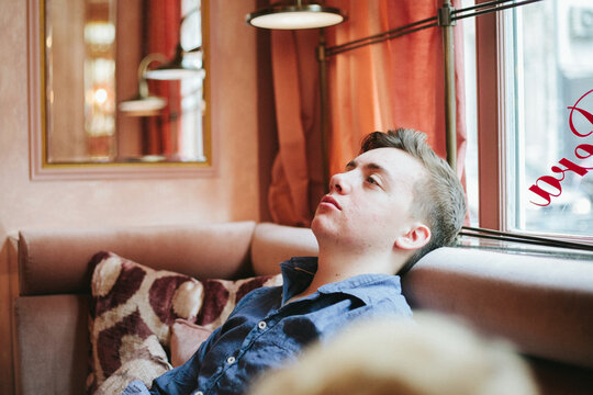 Bored teenager in old-fashioned cafe.