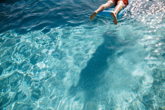 Man Lying On A Lilo In A Swimming Pool