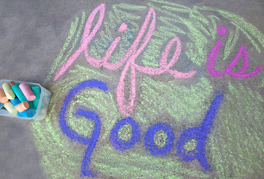 Life is good written in chalk on the ground