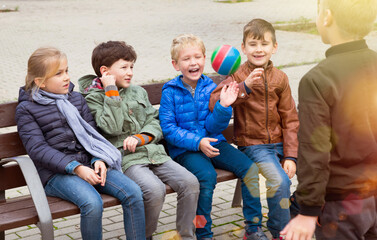 Kids playing ball together on the street. High quality photo