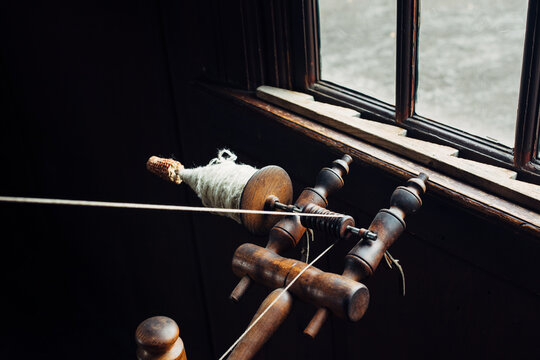 Old wool spinning wheel and spindle