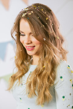 Portrait of a Beautiful Young Woman with Confetti in her Hair