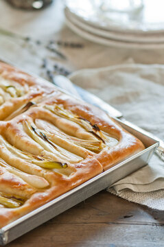 a focaccia with spring onions in a rectangular baking tray